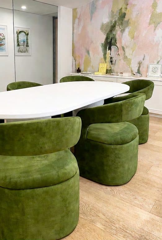 IuMi Studio in Milan, with olive green chairs and a bespoke illustrated wall