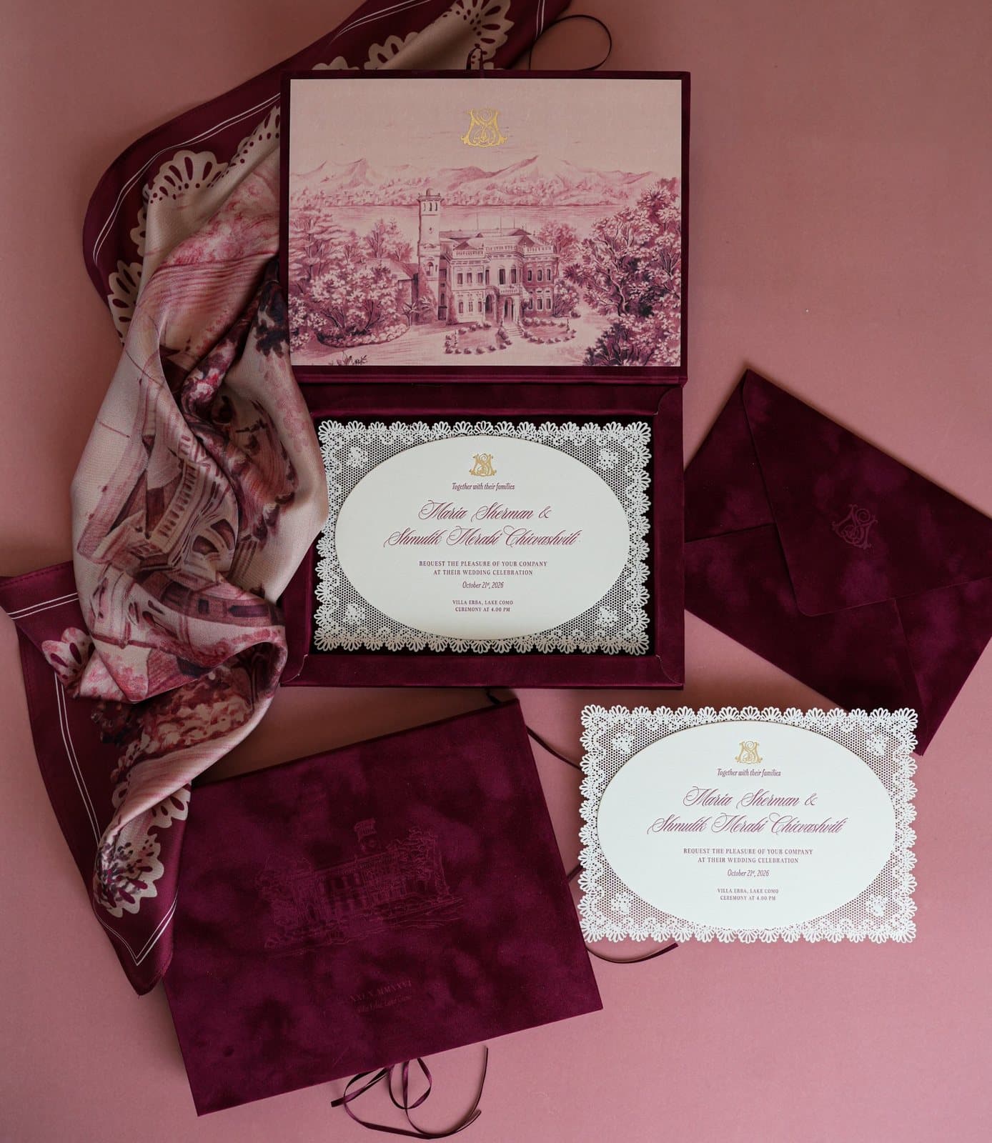 IuMi Studio invitation suite in burgundy velvet: velvet box with an illustrated lake villa and gold foil monogram, lace-cut invitations, velvet envelope and printed silk scarf