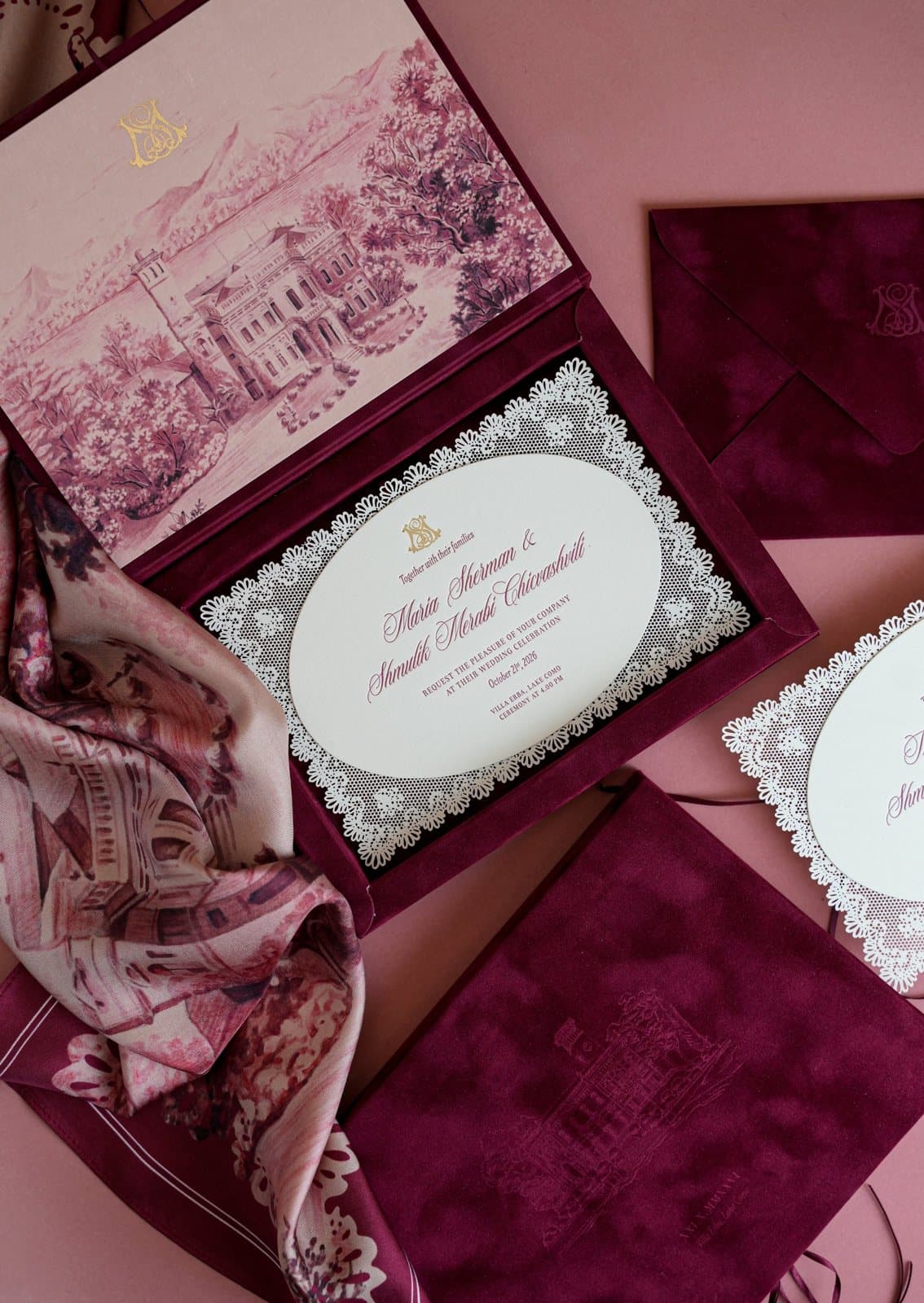 Open velvet box with the illustrated villa and the oval invitation framed by a lace-cut border