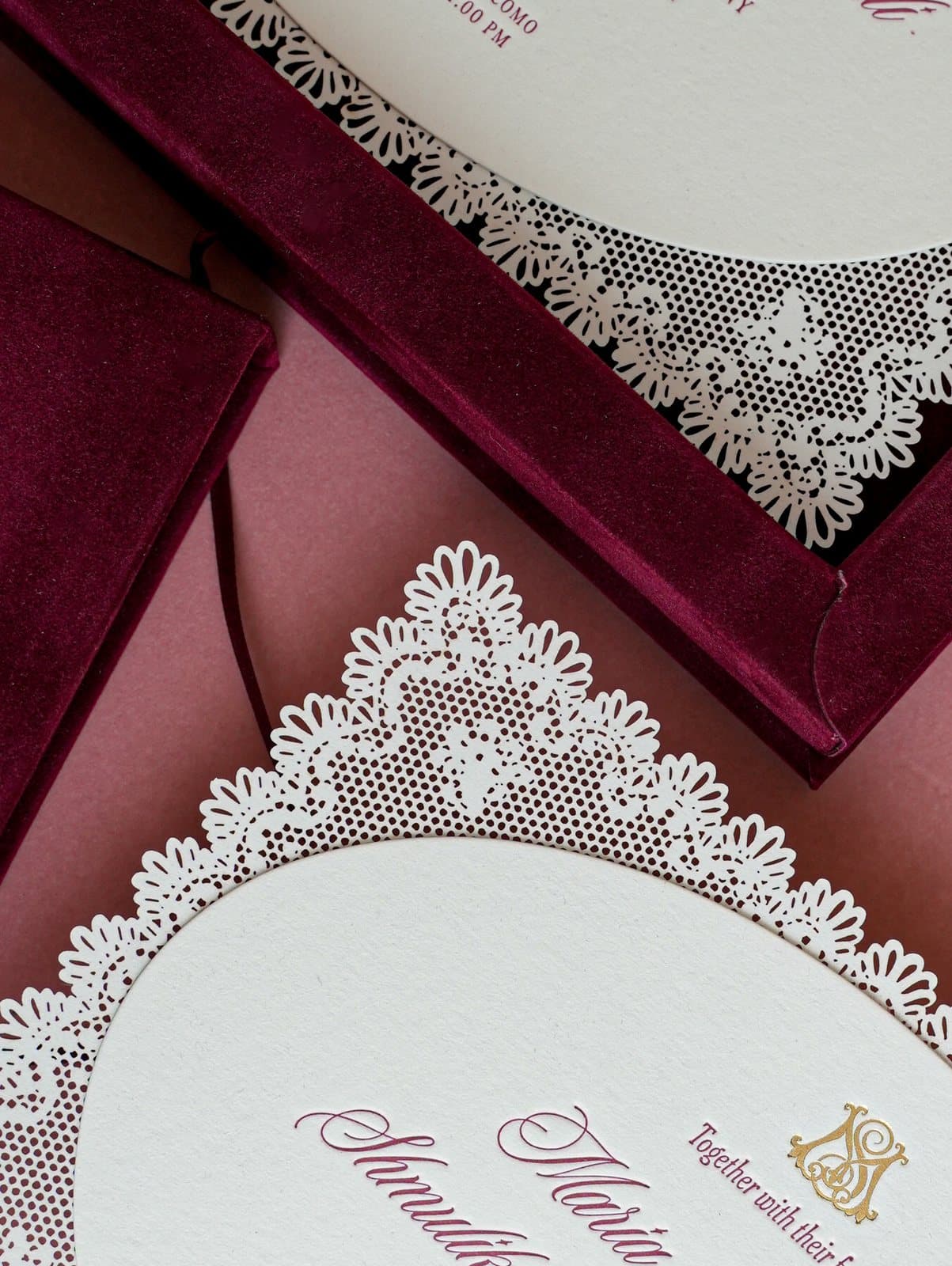 Detail of the laser-cut lace border, letterpress calligraphy and gold foil monogram on the invitation